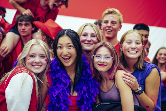 Students smiling while attending a social event