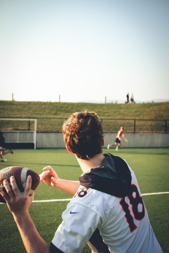 A student ready to toss the football to his friend