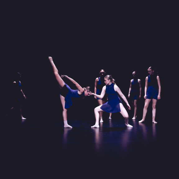 A group of dancers in blue