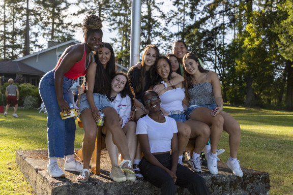 A group of girls smiling at a year end BBQ