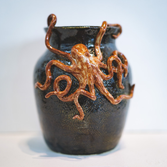 A pot with an octopus on the front