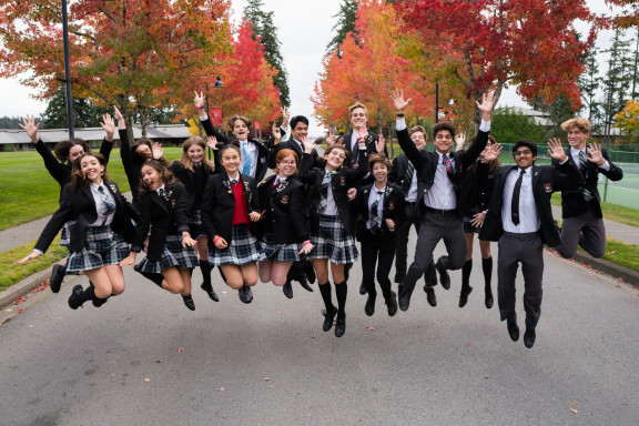 The student executive jumping in the driveway