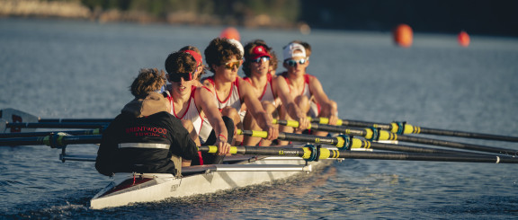 A men's 8+ boat crew mid-sweep from Regatta course start