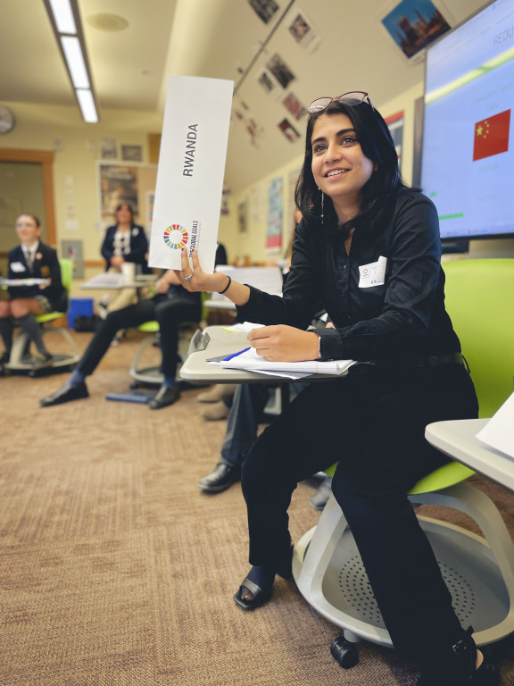 A student holding up a sign at a debate conference