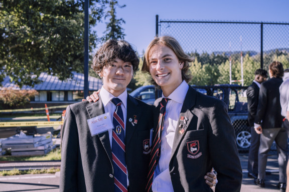 Two private school students in uniform smiling