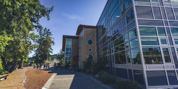 Students working outside in front of the Centre for Arts and Humanities