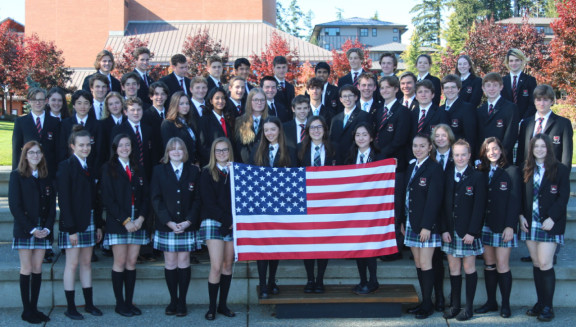 A group of American students holding a US flag on Campbell Commons