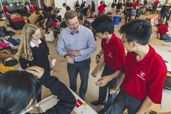 A teacher showing students data on a smart watch