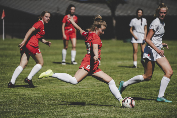 A soccer player kicking the ball