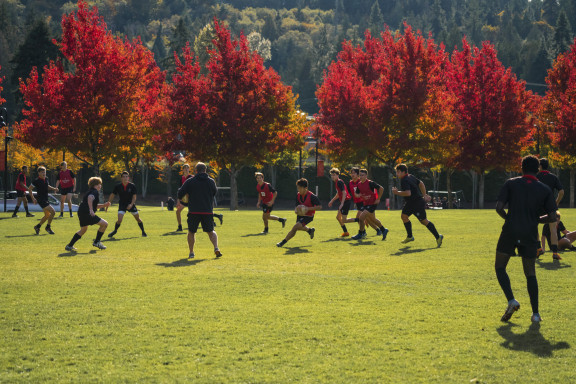 A rugby practice with colourful trees in the background