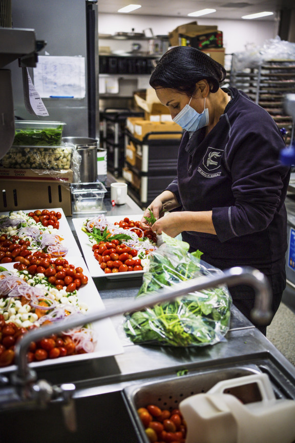Private school chef actively prepares food in the kitchen