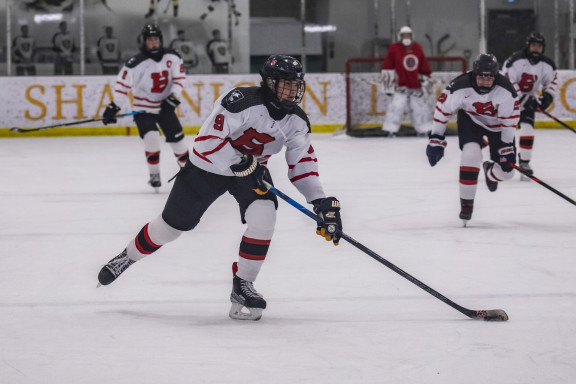 An ice hockey player with the puck