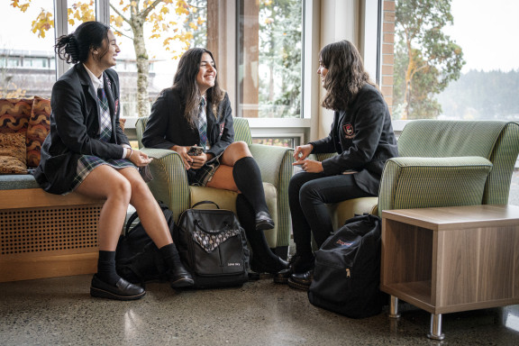Three girls talking in the McNeils Student Centre