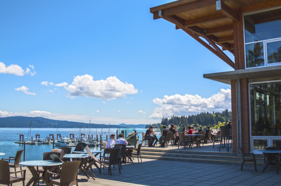 Students eating on a patio overlooking the ocean