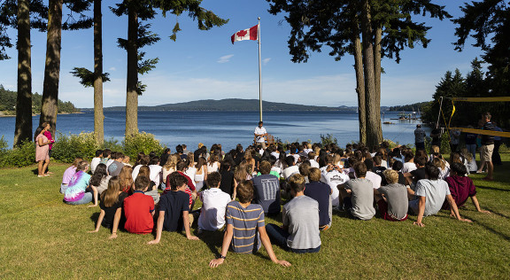 A group of students listening to the Head of School