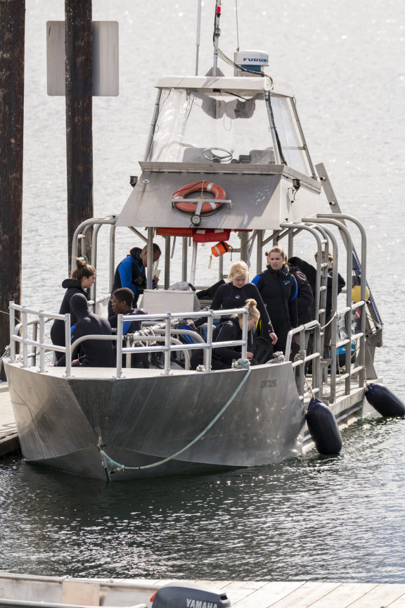 A boat and SCUBA students