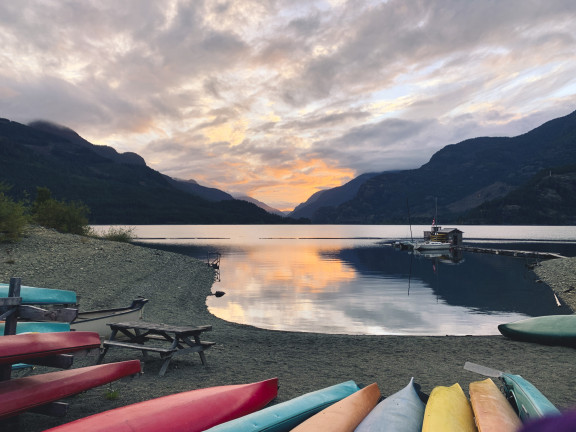 The sun setting over the water and mountains in Strathcona Park