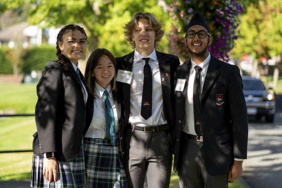Four students smiling for a photo
