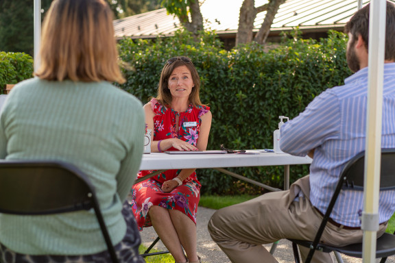 A Houseparent talking with new parents