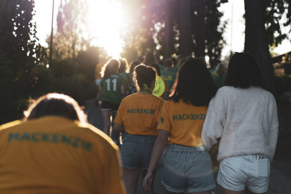 Students walking towards the sun