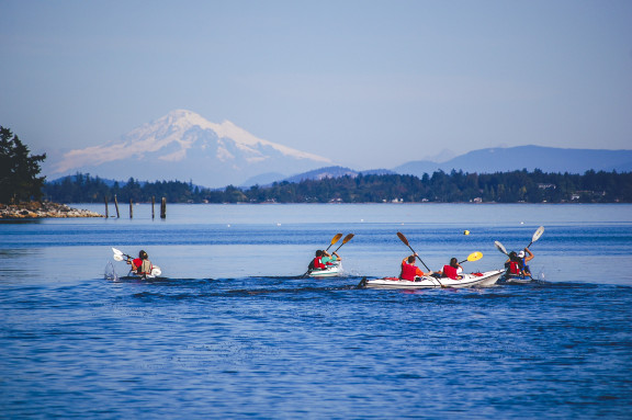 Students kayaking on the waters of Mill Bay