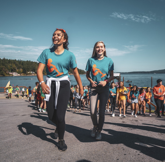 Two students walking up from the water during an inter house competition