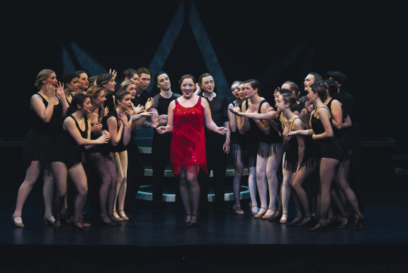 A group of private school students performing in the Musical Chicago