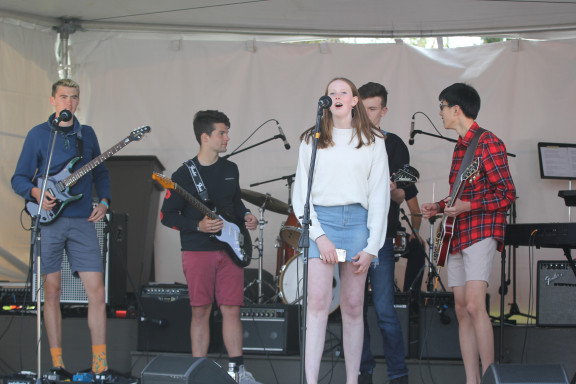A student performing in a band at the regatta stage