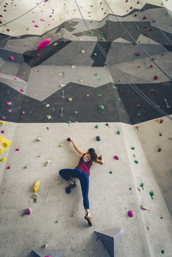 A climber beginning to climb the wall