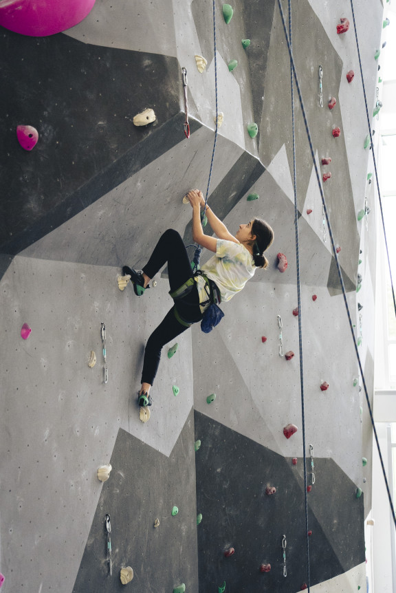 A girl top roping on the climbing wall