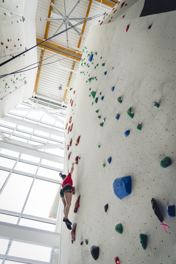 A student race climbing up the speed wall