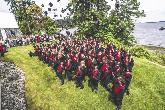 The graduating class tossing their caps in the air