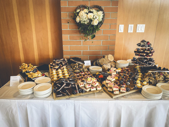 A selection of delectable desserts,piled high and with white rose bouquet