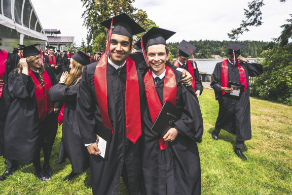 Two students smiling after their graduation