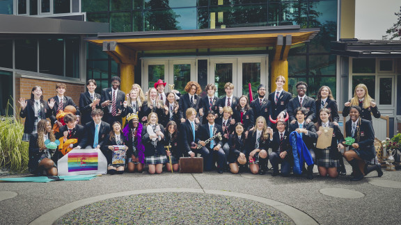 A group of student leaders smiling in front of the arts centre