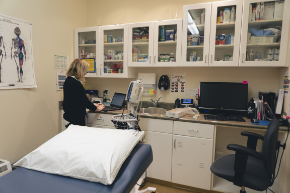 A nurse works at a computer in the Health Centre