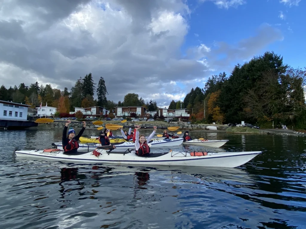Students sea kayaking together on the water