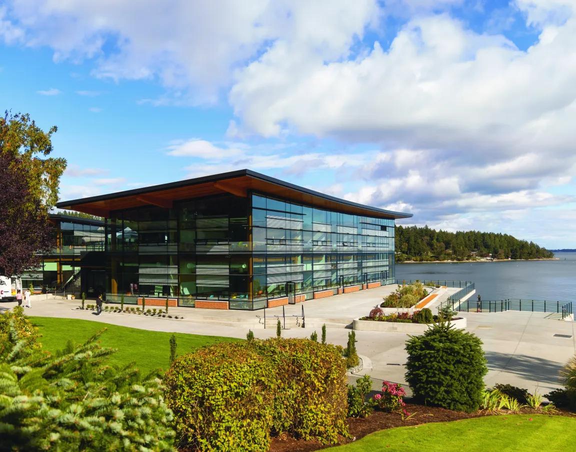 Exterior view of the modern Centre for Innovation and Learning (CIL) building at Brentwood College School under a blue, cloudy sky.
