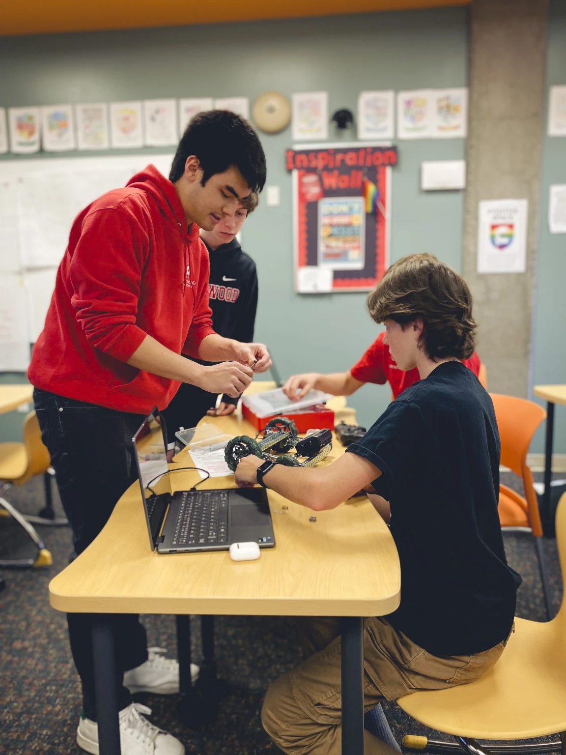 Grade 8 students building a robot in class
