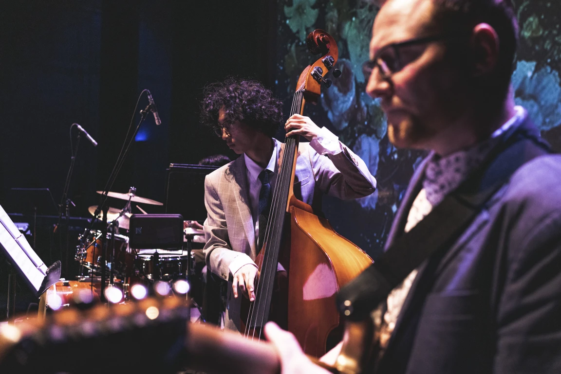 A bass player playing the stand up bass