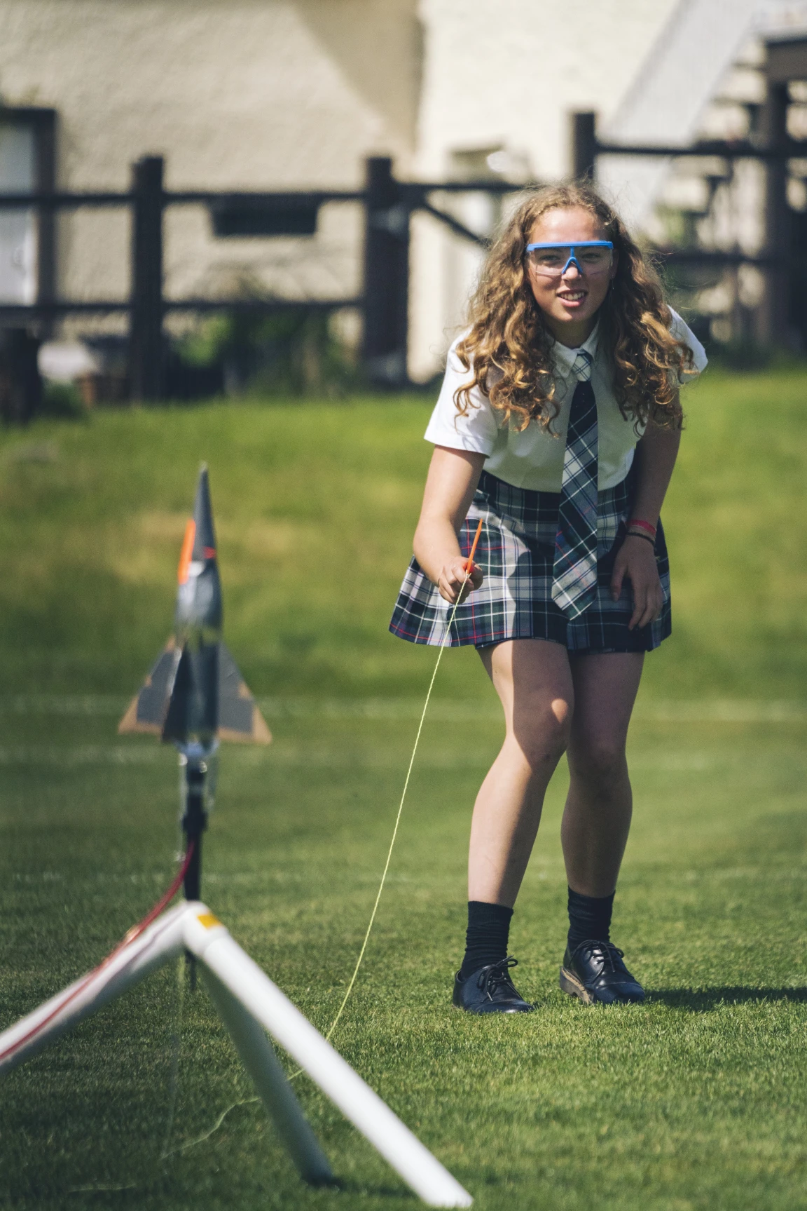 A private school student firing off a water propelled rocket