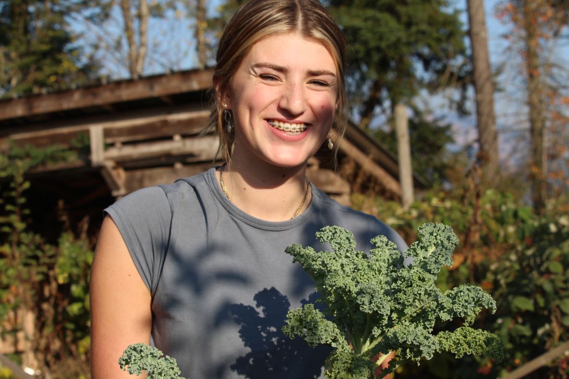 Student smiling during trip to local farm