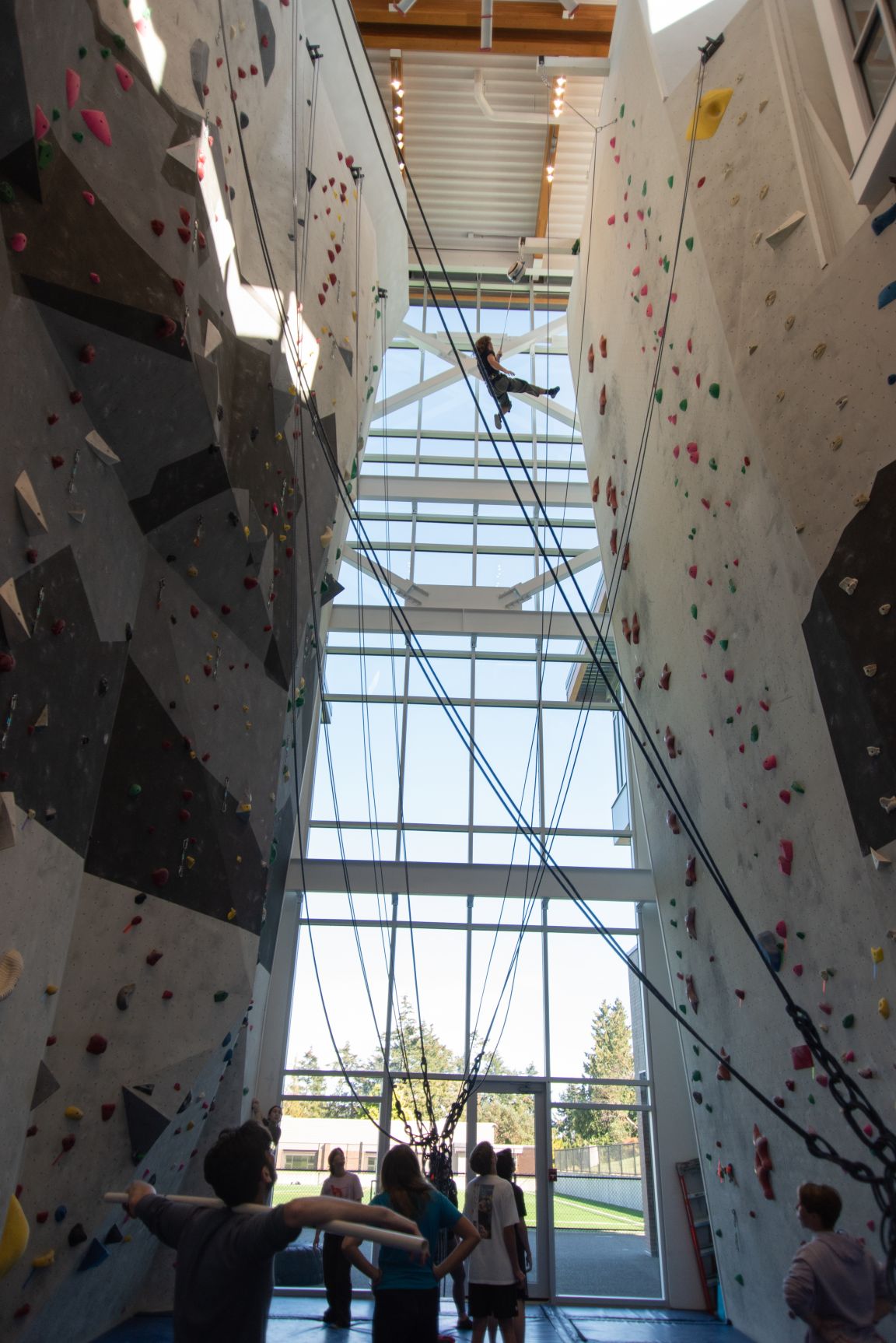 A student climbing the 50-foot indoor climbing wall in the athletics centre