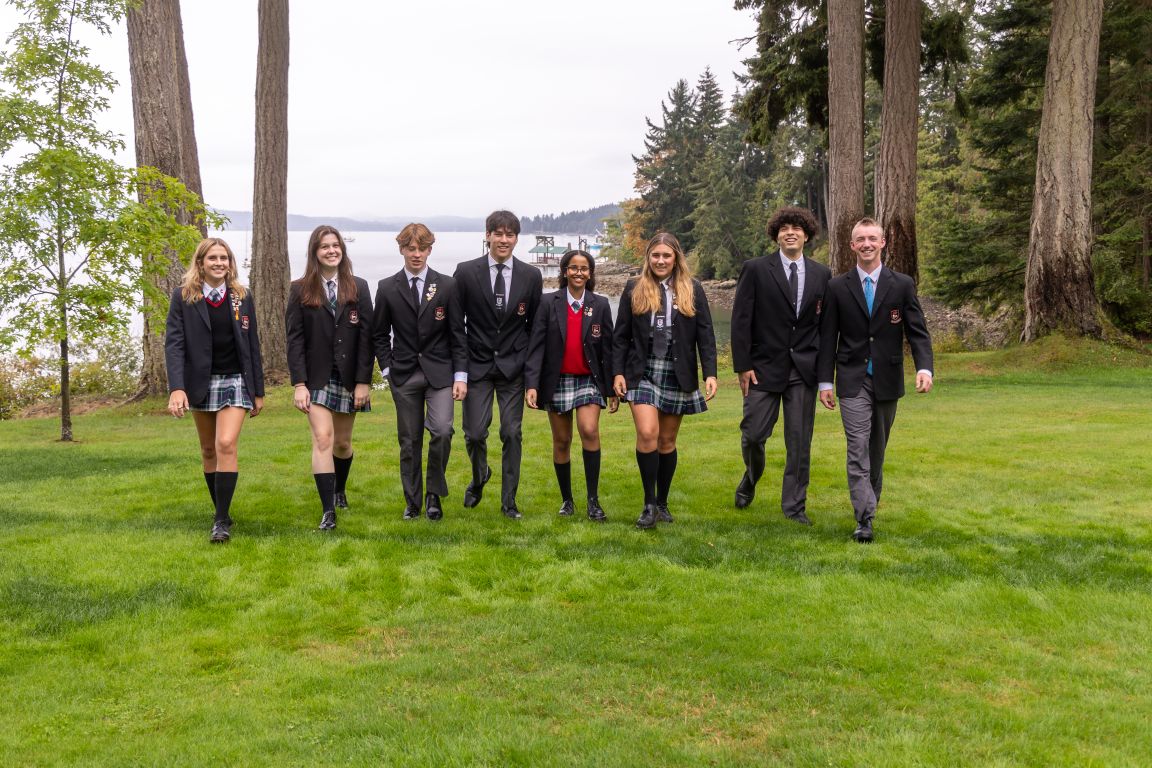 Private school students walking on grass