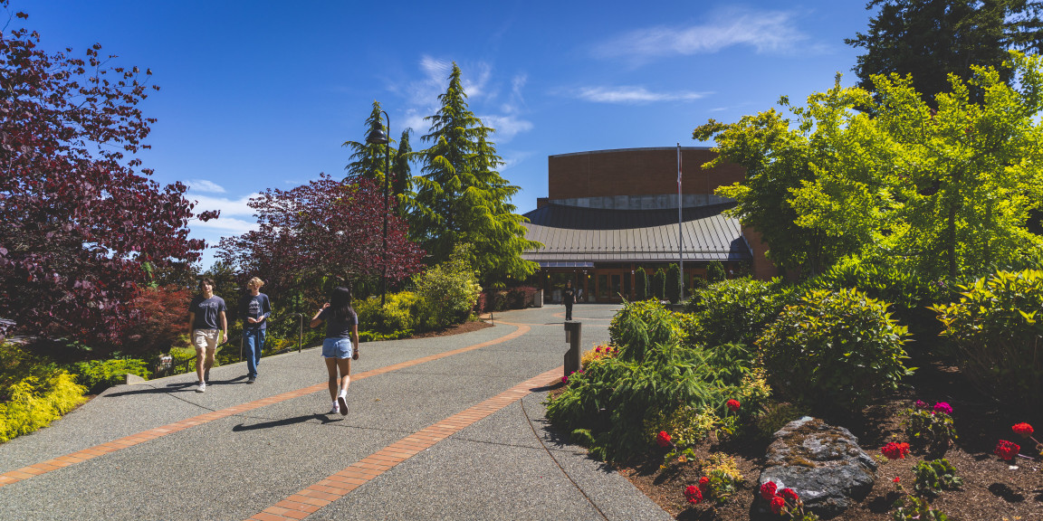 Students walking along a path toward the T. Gil Bunch Centre
