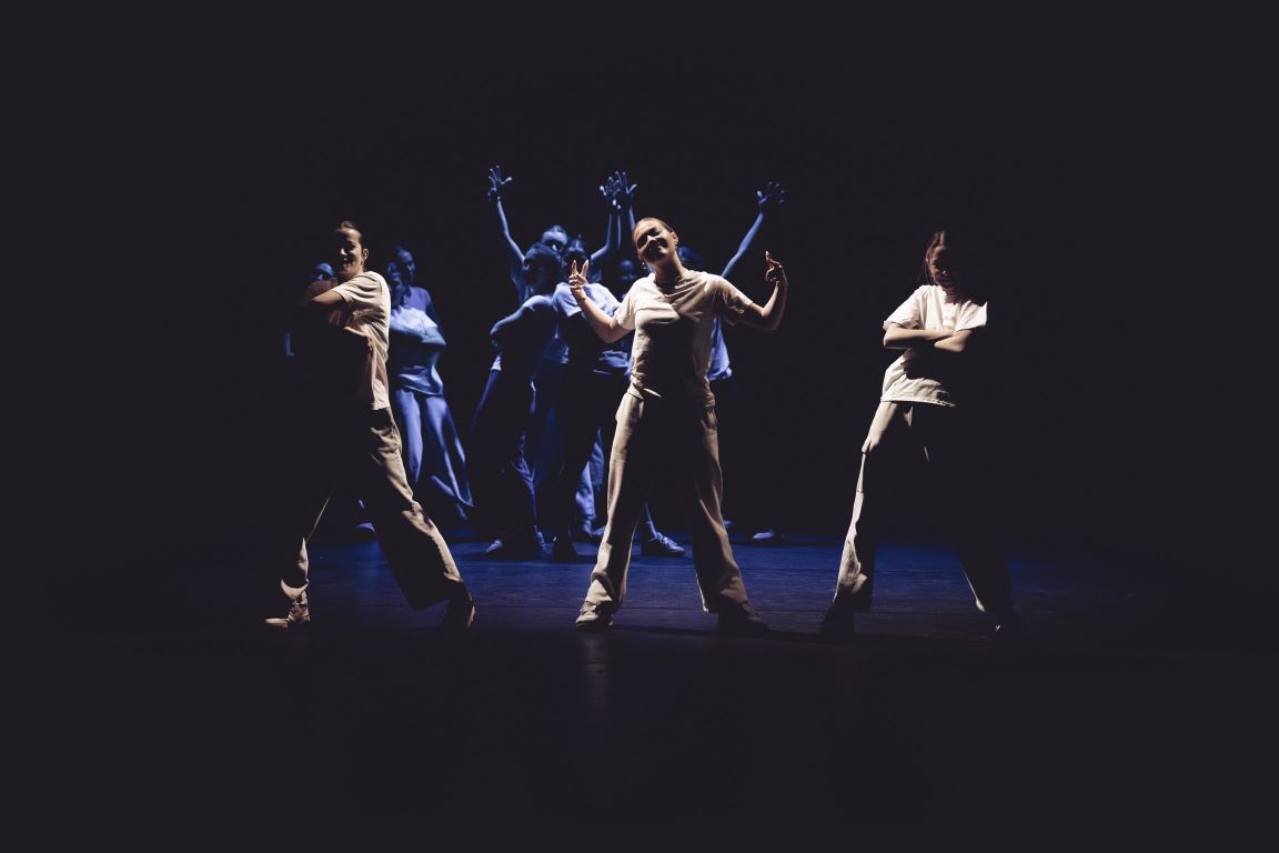 Students performing a contemporary dance on stage