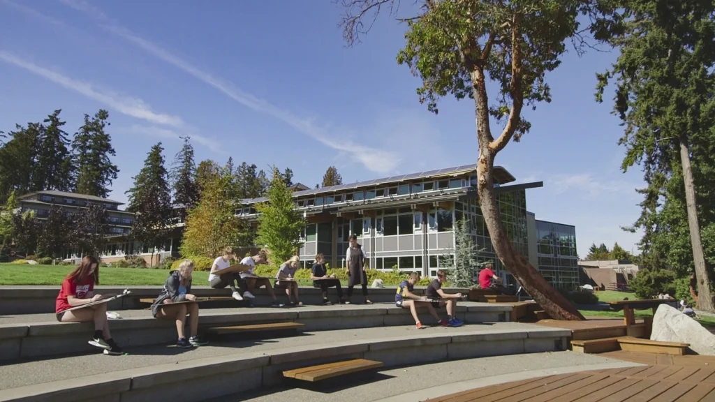 Students relaxing on outdoor terraced seating on the Brentwood campus