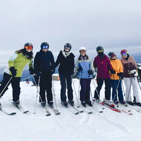 A group of students skiing together on a snowy mountain