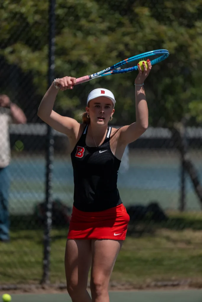 A tennis player preparing to serve