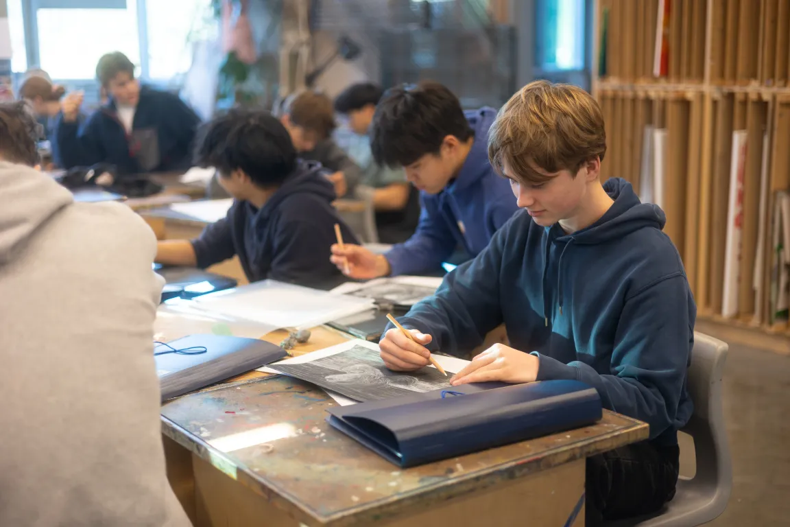 Students at work on drawings in 2D art class